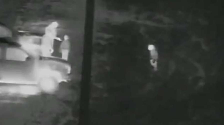 Smuggler seen dropping young girls over border fence to distract agents