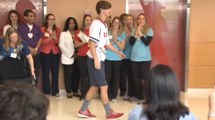 Paralyzed lacrosse player walks out of hospital
