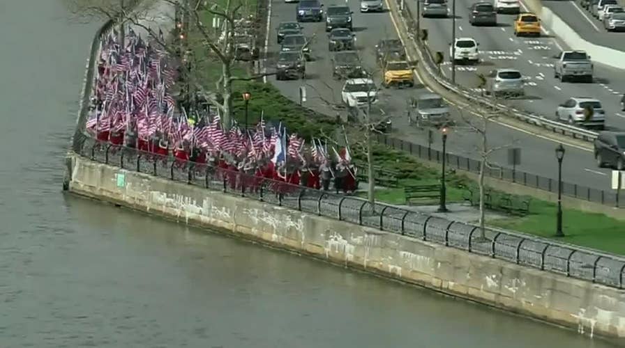 New York firefighters run with french flags in tribute to Notre Dame crews