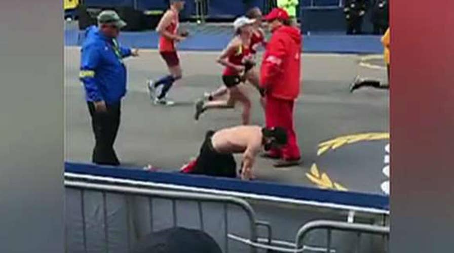 Determined Marine veteran crawls across Boston Marathon finish line