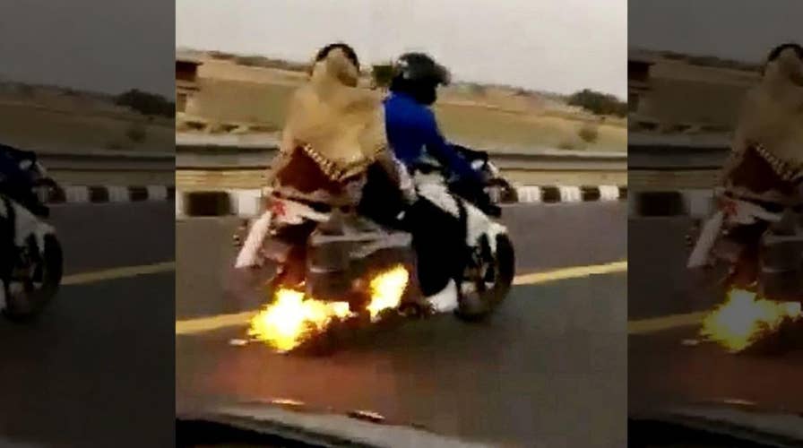 Police save family aboard flaming motorcycle