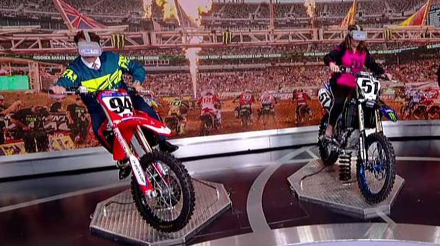 Anthony Scaramucci and Jedediah Bila face off in a virtual motorcycle race