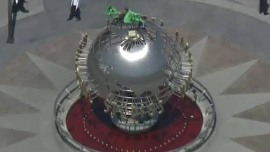 Protesters climb Universal Studios globe in California demanding NBC take climate-change action