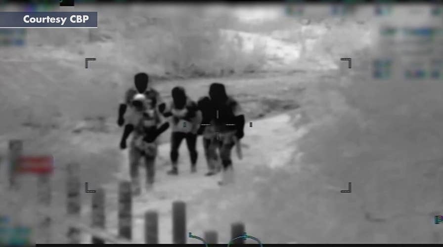 Surveillance video appears to show armed men help woman cross border