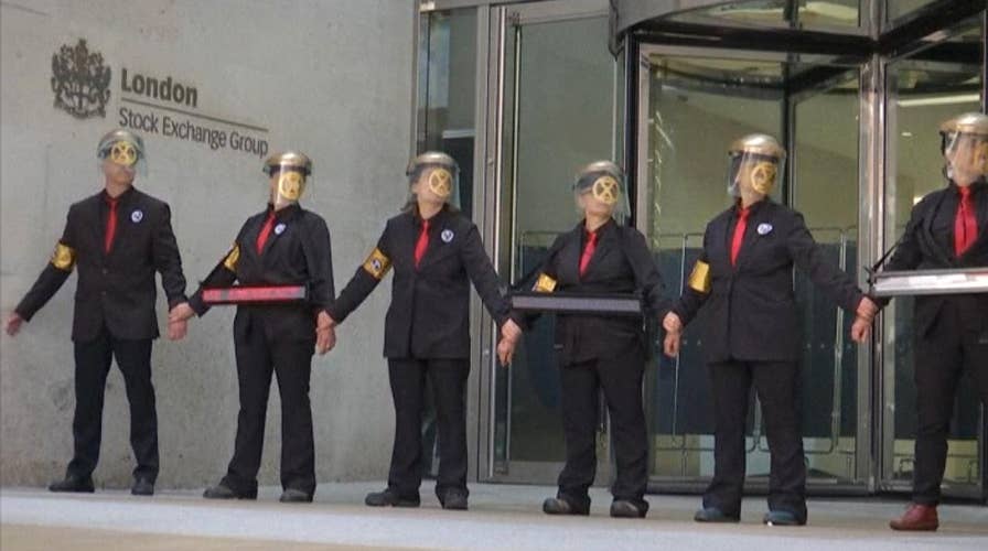Climate activists glue themselves together outside London Stock Exchange
