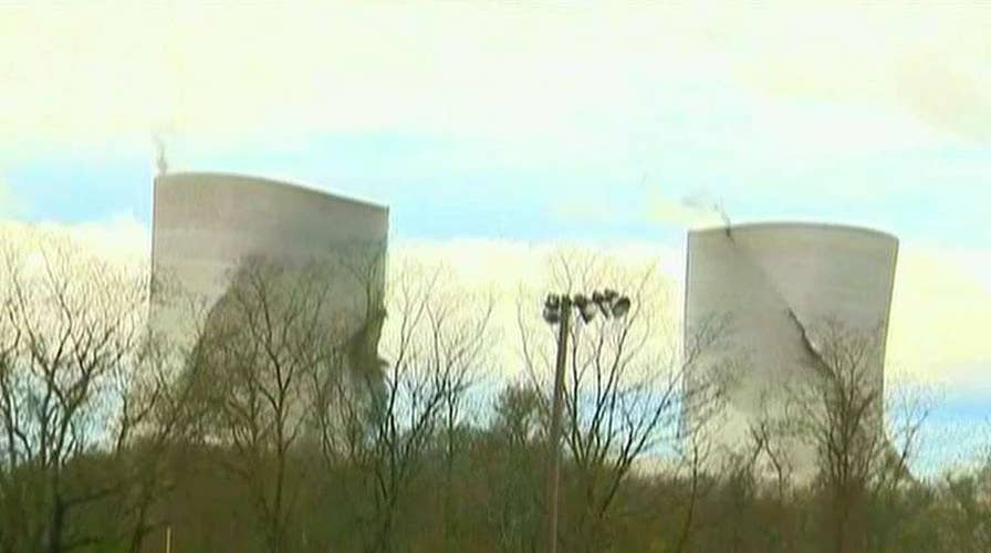Crews implode two cooling towers