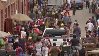 Thousands of Venezuelans cross Colombian border seeking supplies