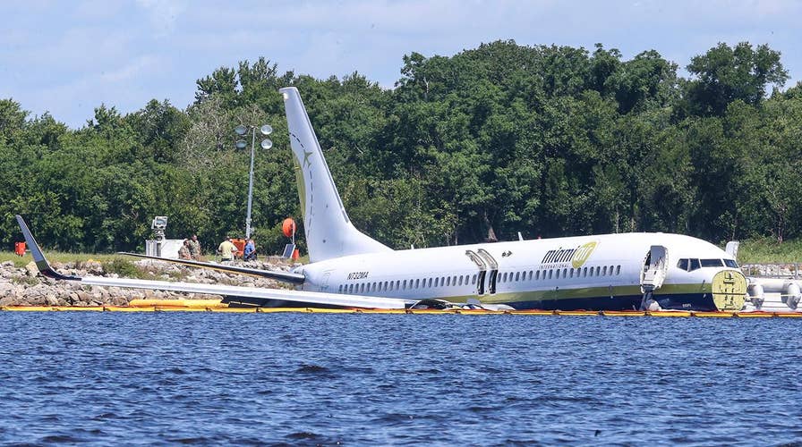 Boeing 737 plane carrying 143 people skids off runway into river