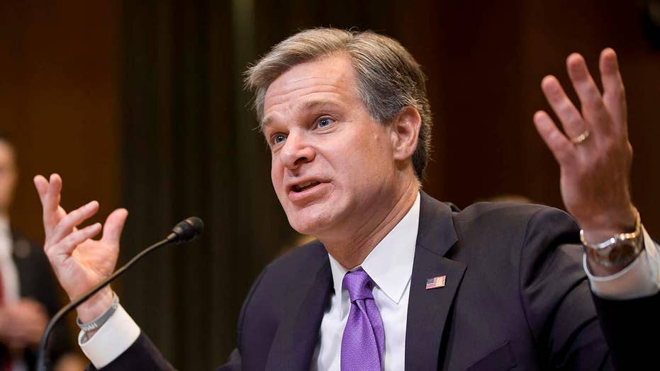 FBI Director Wray breaks with Attorney General Barr over whether the government "spied" on Trump campaign