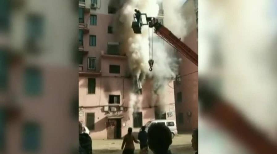 Crane operator saves 14 people from burning building in China