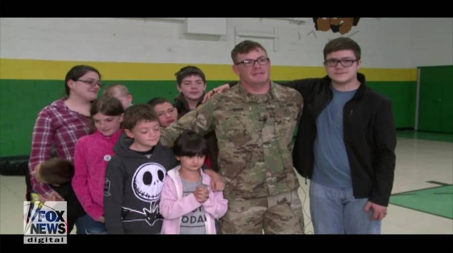 Soldier surprises his kids at school with early homecoming