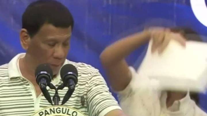 President Rodrigo Duterte of the Philippines gets interrupted by a cockroach during rally