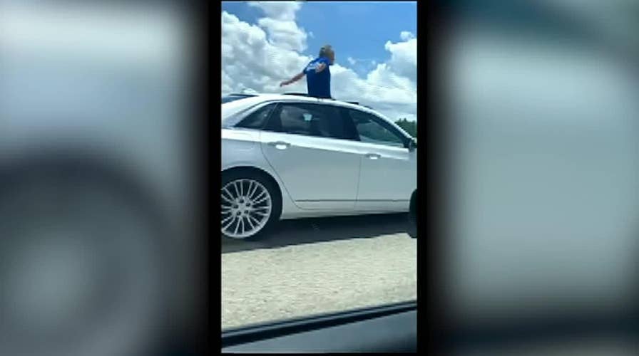 Florida man stands in sunroof while driving