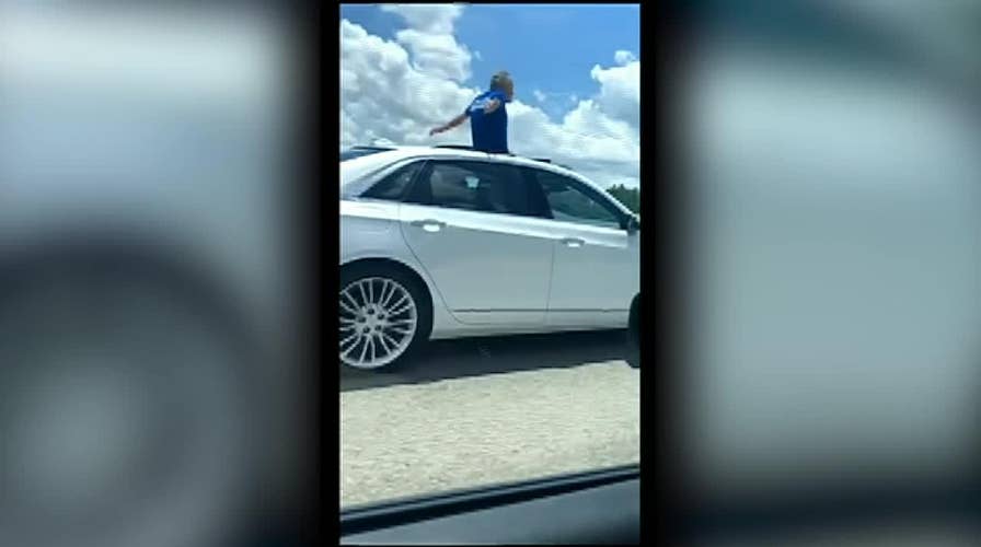 Florida man stands in sunroof while driving