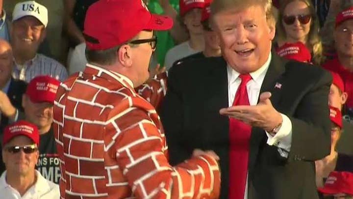 Trump supporters cheer for the border wall at Trump rally