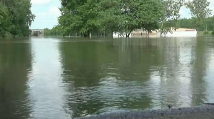 Family-owned business, veteran prepare for the worst by placing sandbags at storefronts.