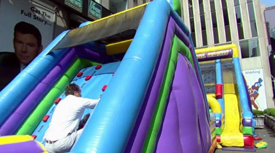 Ed and Pete compete on the ultimate inflatable obstacle course