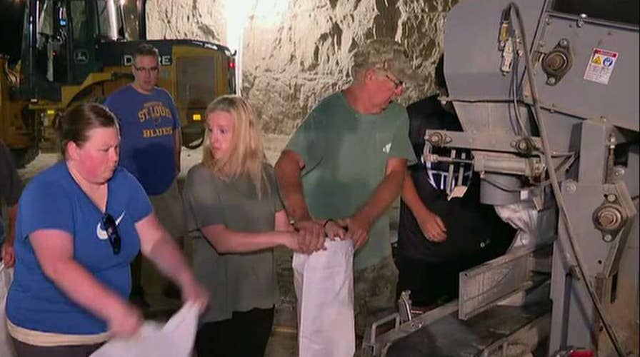 Hundreds of Illinois volunteers work to fill sandbags to fight Mississippi River flooding