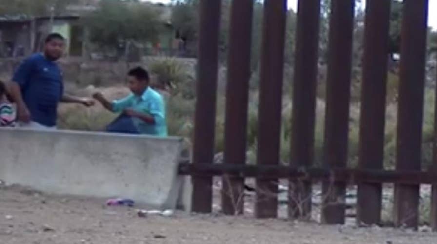 Footage of U.S.-Mexico border shows armed coyote smuggling dozens into the U.S.