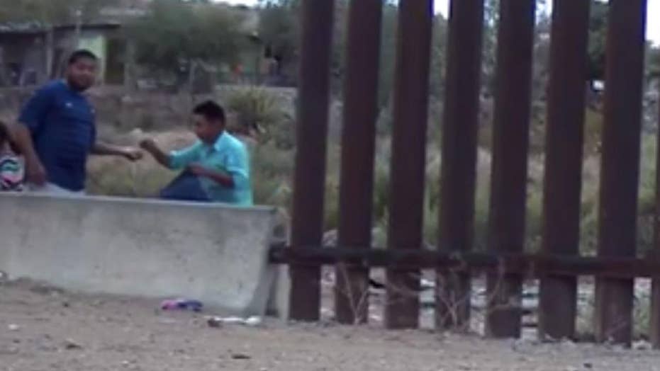 Footage of U.S.-Mexico border shows armed coyote smuggling dozens into the U.S.