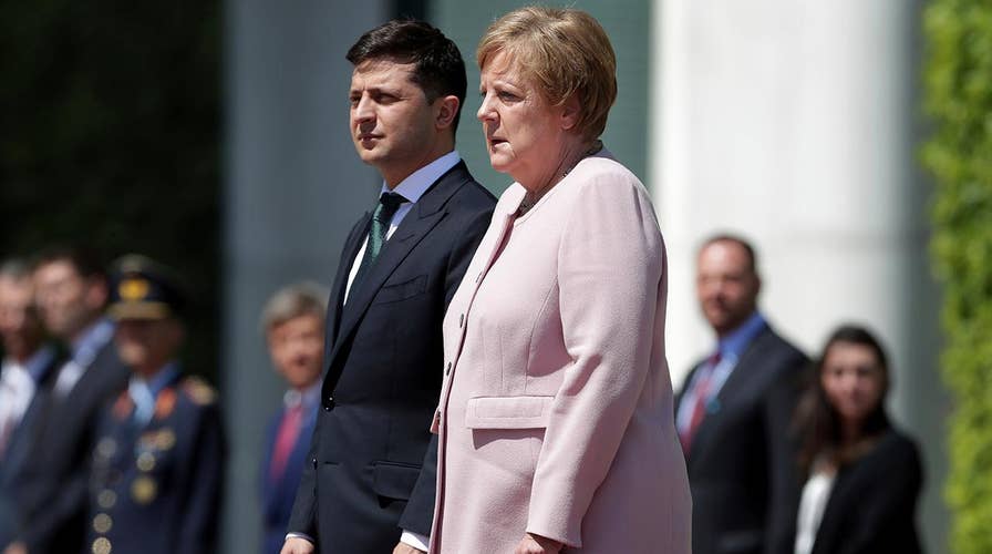 Angela Merkel appears to shake uncontrollably at ceremony with the new Ukrainian president