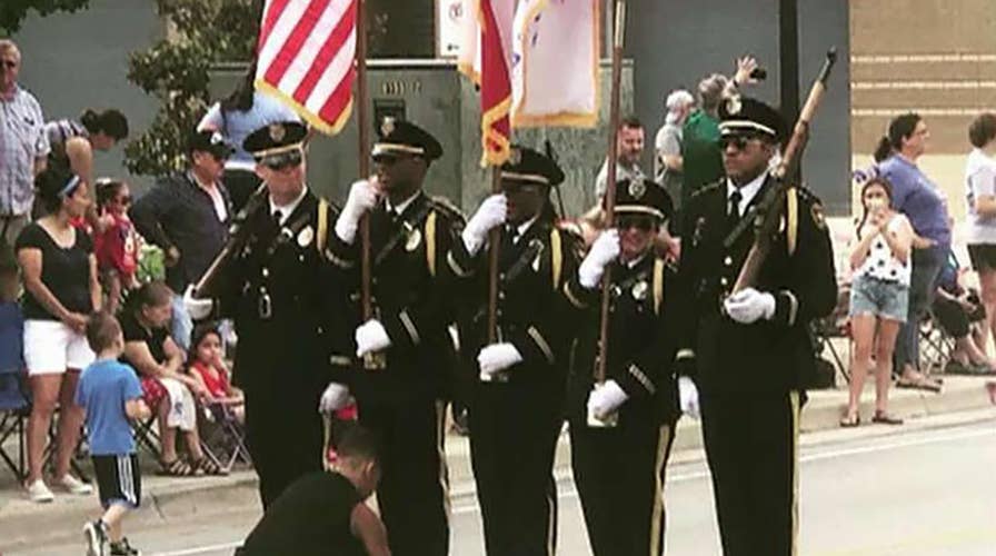 Boy steps in to tie honor guard's shoe during Texas Fourth of July parade