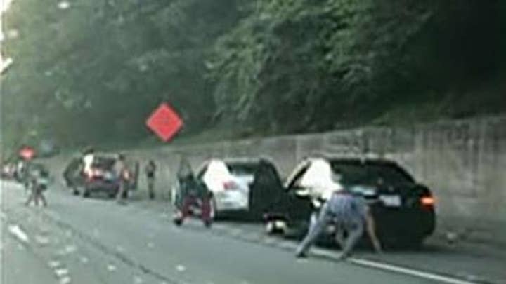 Armored car spills thousands of dollars on Georgia highway, drivers run out of vehicles to grab the cash