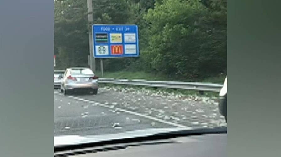 Raw Video: Drivers in Georgia pull over to pick up money flying all over an interstate