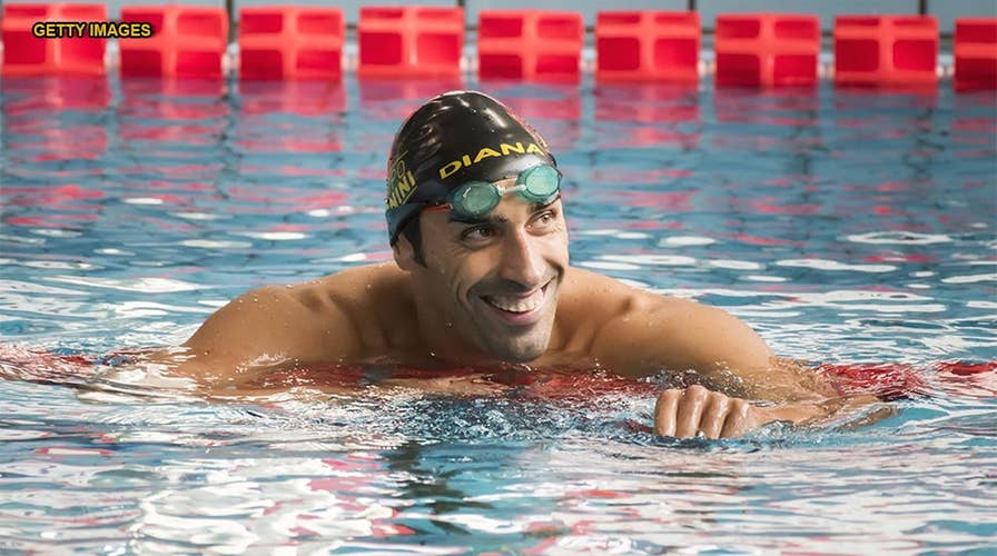 Olympic championship swimmer Filippo Magnini rescues man drowning after falling off inflatable unicorn