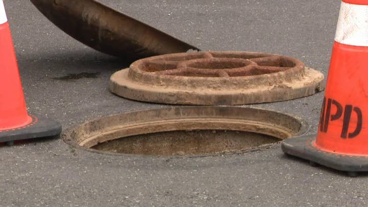 Fire and rescue teams pull two unresponsive men from a manhole in Pennsylvania