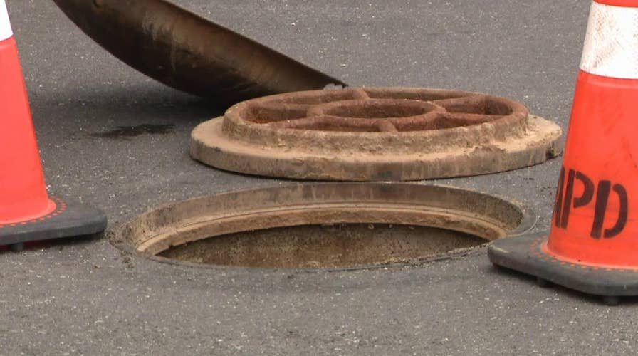 Fire and rescue teams pull two unresponsive men from a manhole in Philadelphia