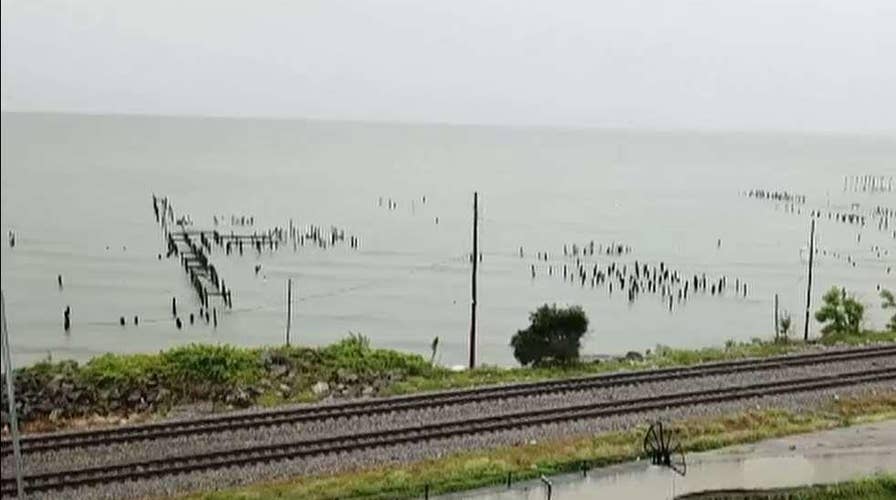 New Orleans residents eye swollen Mississippi River as strengthening storm approaches