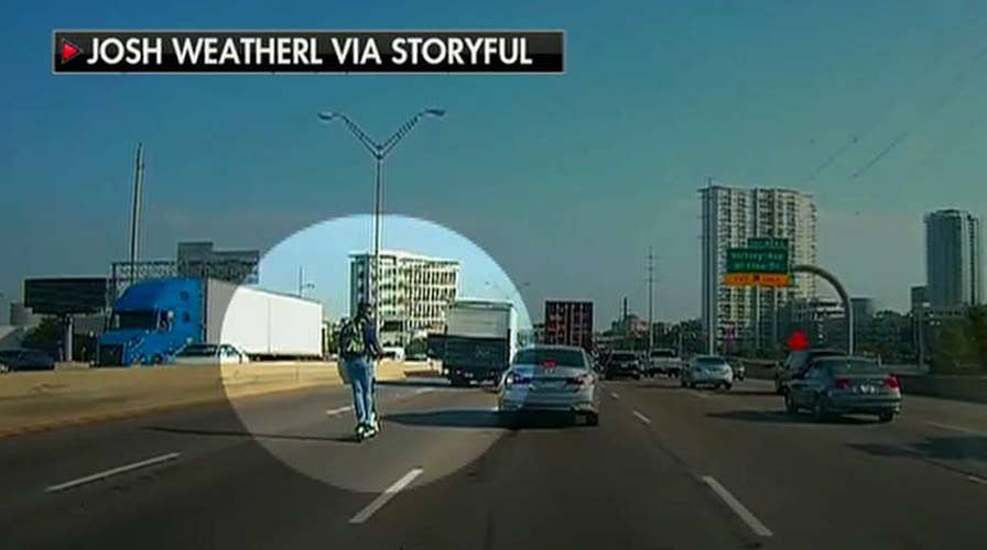 Man spotted riding scooter in rush hour traffic