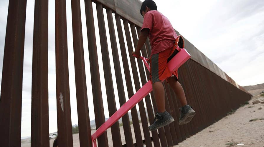 Pair of professors builds a set of fluorescent pink seesaws across the US-Mexico border