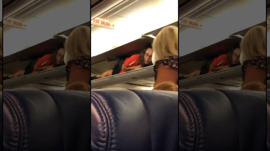 Southwest Airlines flight attendant inside overhead compartment 'perplexes' passenger 