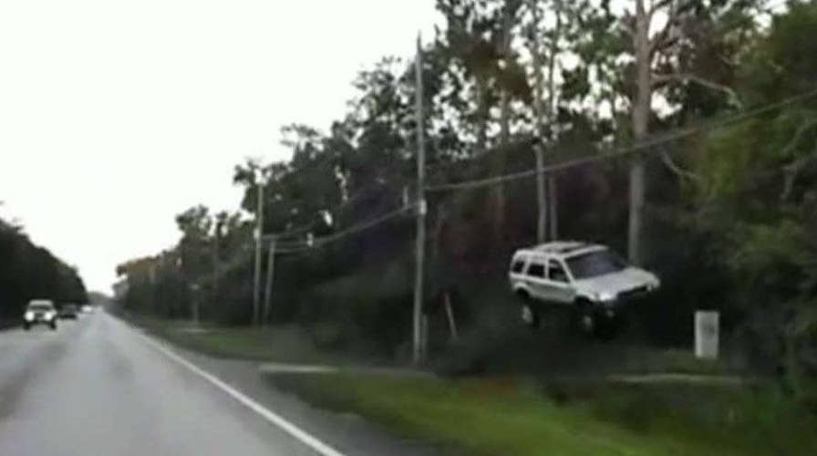 Off-duty officer Rich Gardner rescued two people after their SUV went airborne and crashed into a tree in New Smyma Beach Florida