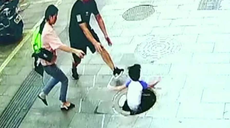 3-year-old falls through manhole in China, dad pulls him out