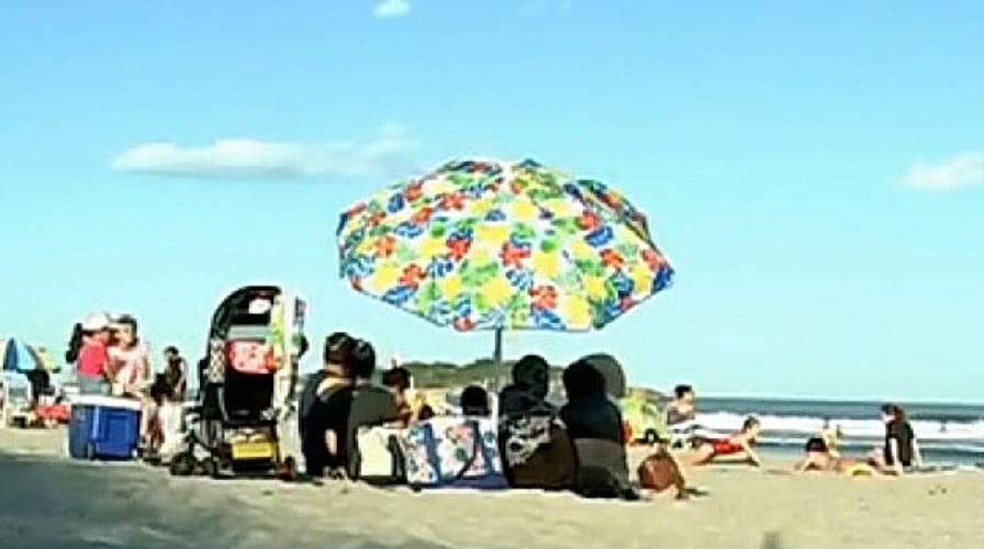 Teen hospitalized after being struck by beach umbrella