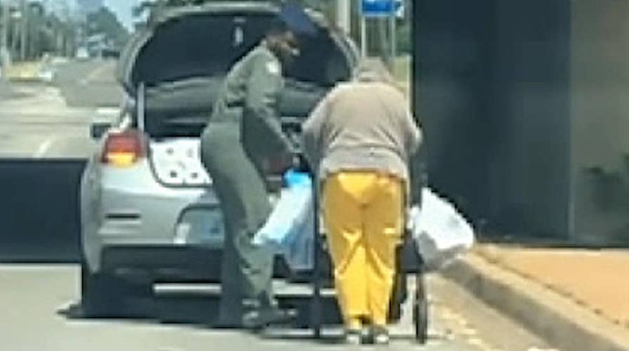 Oklahoma Airman helps elderly woman take home groceries