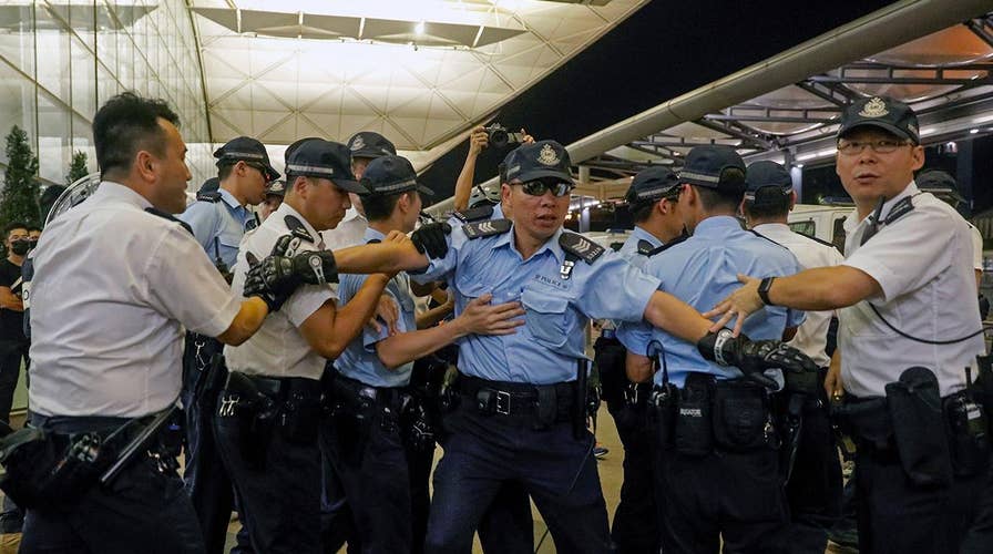 Riot police clash with protesters at Hong Kong airport