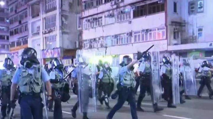 Hong Kong riot police blanket streets in standoff with protesters