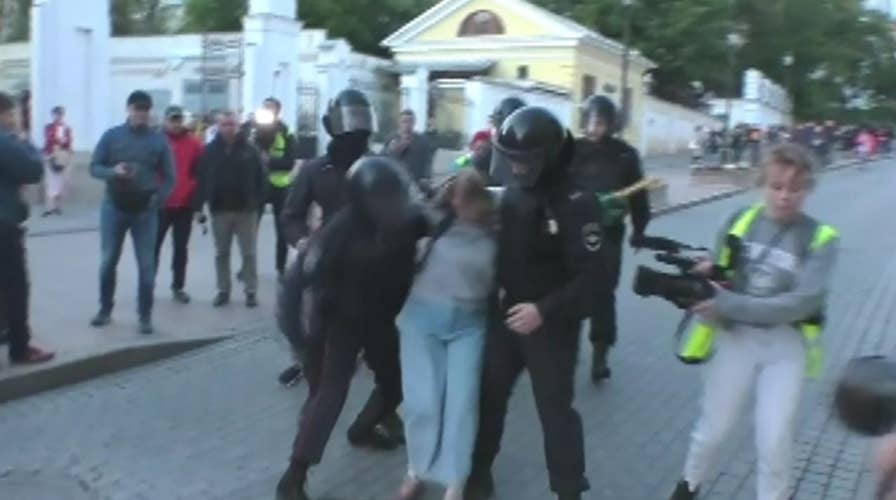 Russian policeman punches female protester during Moscow protest