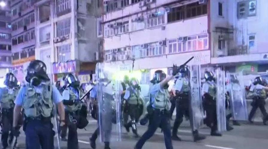 Hong Kong riot police blanket streets in standoff with protesters