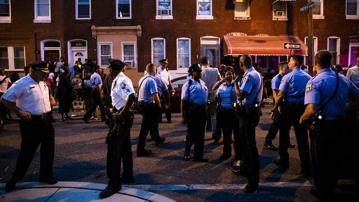Philadelphia residents taunt police officers during standoff