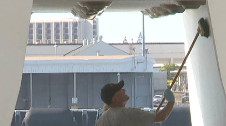 Navy volunteers help clean the USS Arizona Memorial