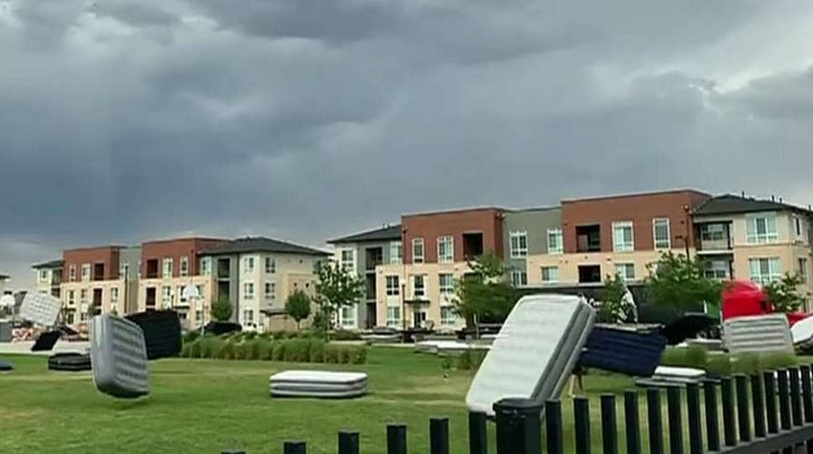 Strong wind gusts send dozens of mattresses flying through air