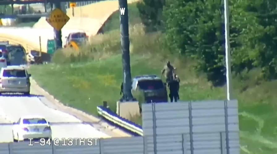 Three men seen riding scooters along highway