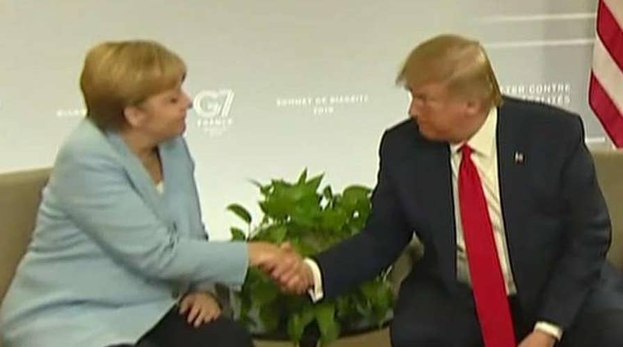 Trump meets with German Chancellor Merkel, strikes bilateral trade deal with Japan at the G7 summit