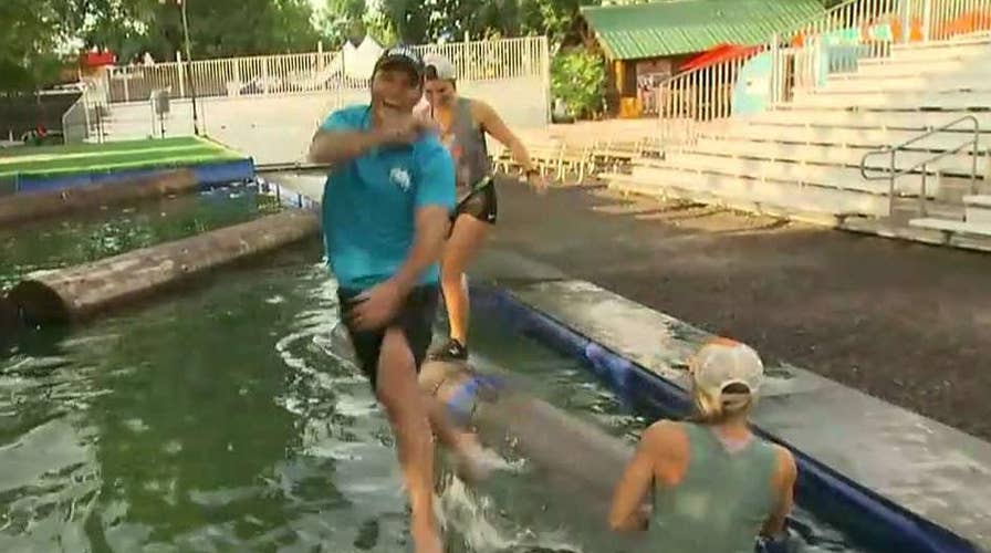 Pete Hegseth tries logrolling at the Minnesota State Fair