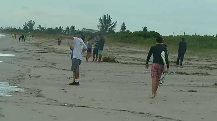Hurricane Dorian: Residents walk beach as conditions improve in Indialantic, Florida